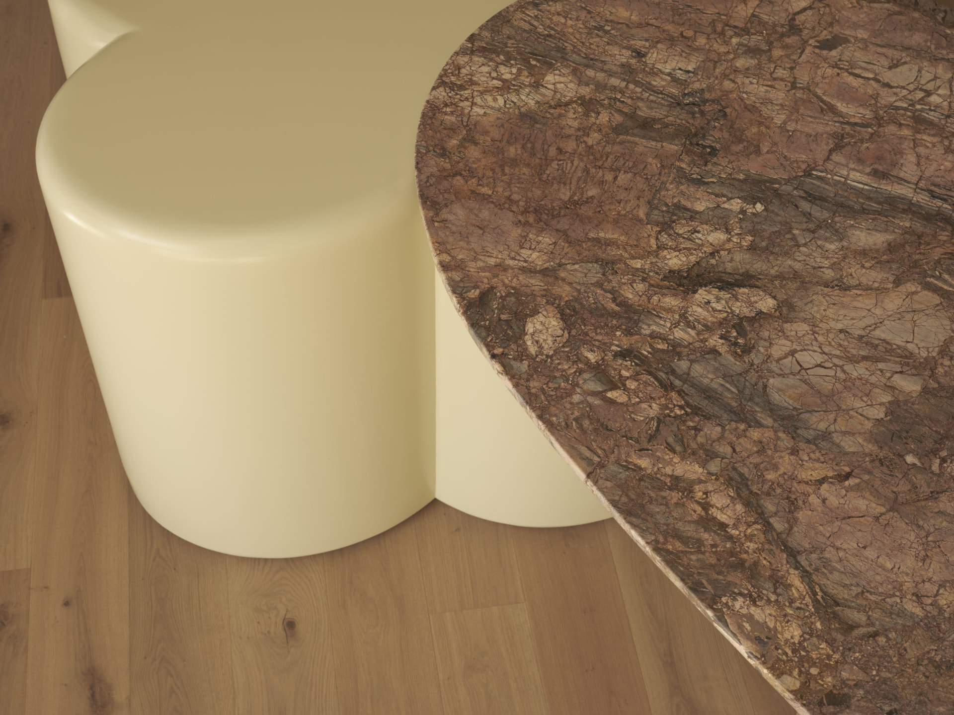 Detail of buttermilk lacquer clover base and marble table top on oak flooring