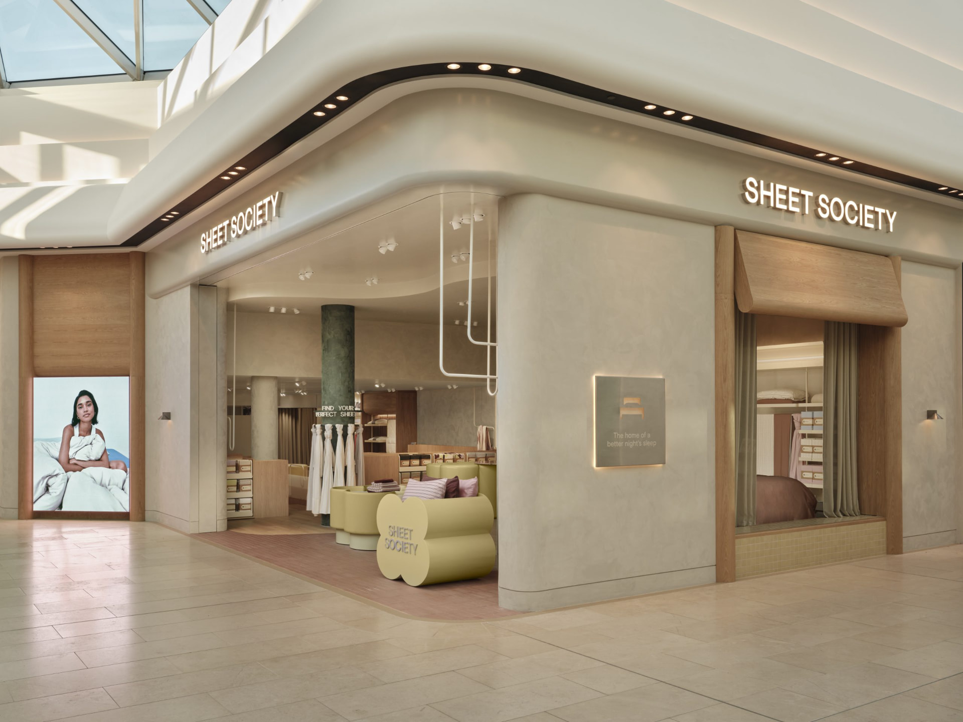 Sheet Society Burnside shopfront with curved plaster portal, oak reveals and illuminated signage